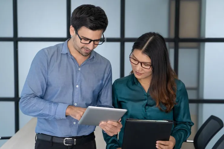 OthTech consultants reviewing a project on a tablet